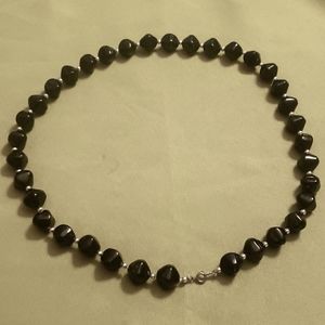 Long string of plastic black and silver colored beads.